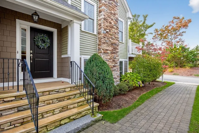 a front view of a house with a garden