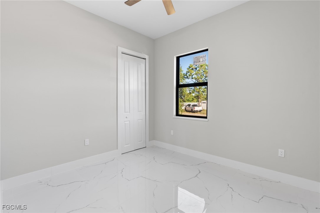 2603 3rd Street Southwest Lehigh Acres, FL 33976 - Photo 13 of 28 an empty room with windows