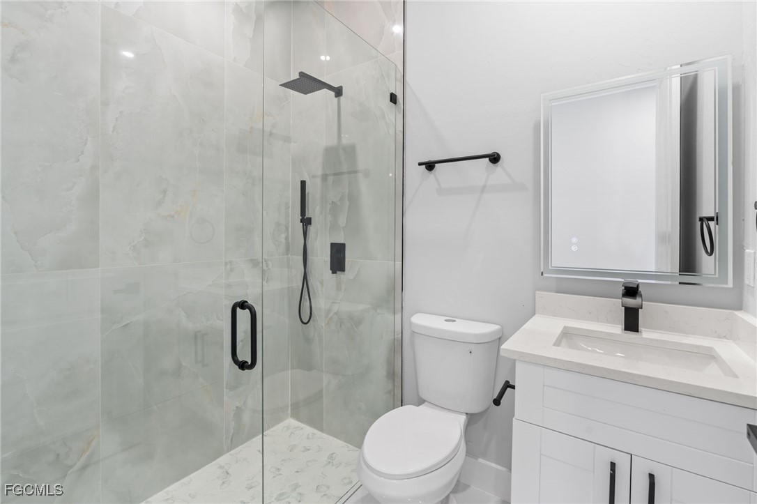 2603 3rd Street Southwest Lehigh Acres, FL 33976 - Photo 14 of 28 a bathroom with a sink toilet and shower