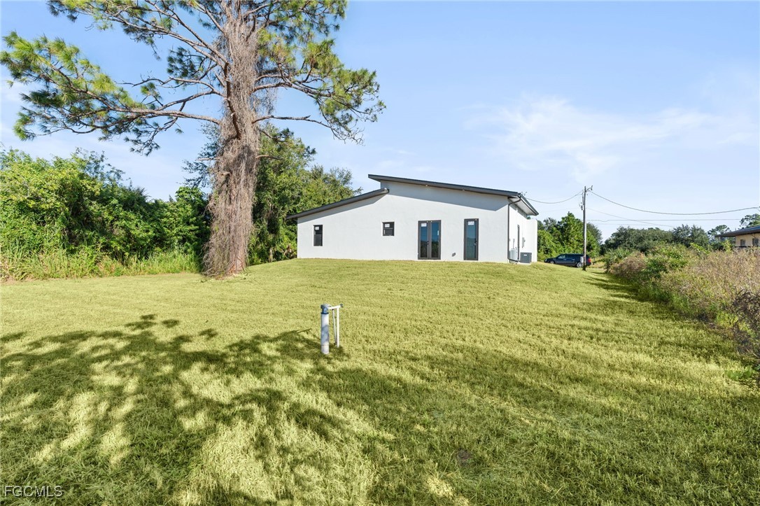 2603 3rd Street Southwest Lehigh Acres, FL 33976 - Photo 21 of 28 a house view with a garden space