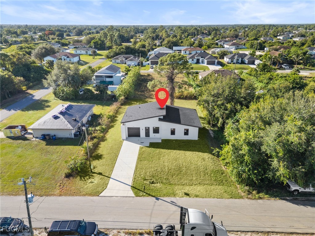 2603 3rd Street Southwest Lehigh Acres, FL 33976 - Photo 25 of 28 an aerial view of residential houses with outdoor space