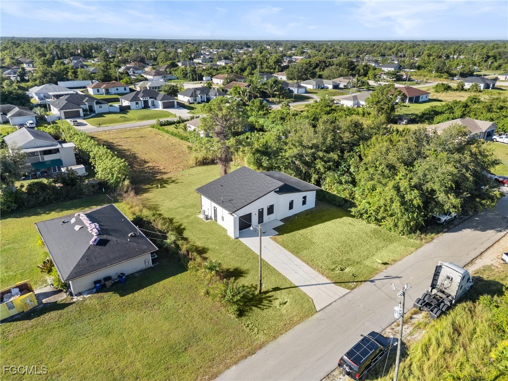 2603 3rd Street Southwest Lehigh Acres, FL 33976 - Photo 26 of 28 an aerial view of a house with a swimming pool yard and outdoor seating