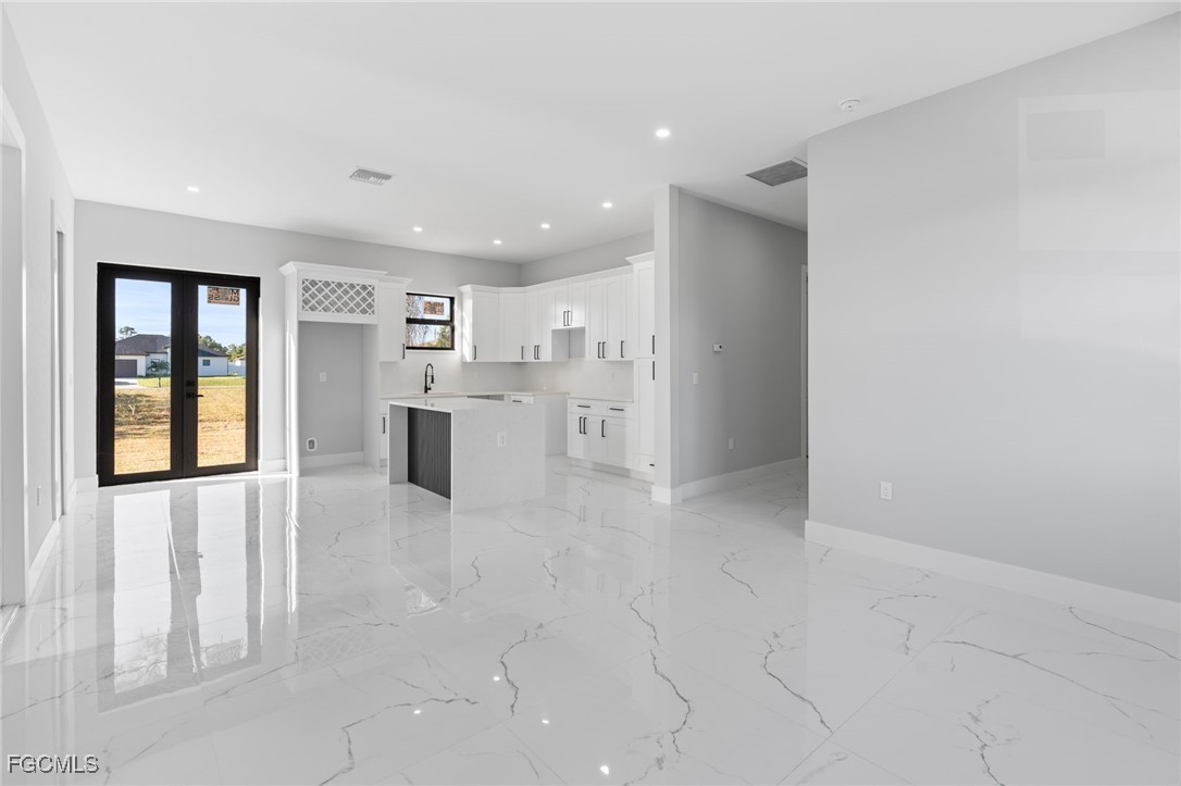 2603 3rd Street Southwest Lehigh Acres, FL 33976 - Photo 3 of 28 a view of a kitchen with refrigerator and windows