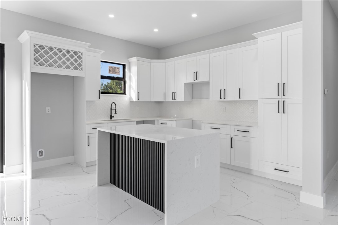 2603 3rd Street Southwest Lehigh Acres, FL 33976 - Photo 4 of 28 a kitchen with white cabinets and sink