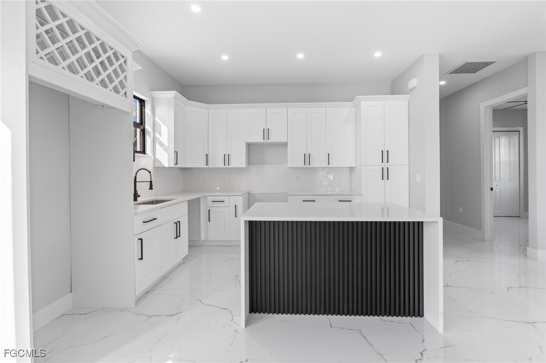 2603 3rd Street Southwest Lehigh Acres, FL 33976 - Photo 5 of 28 a kitchen with cabinets and stainless steel appliances