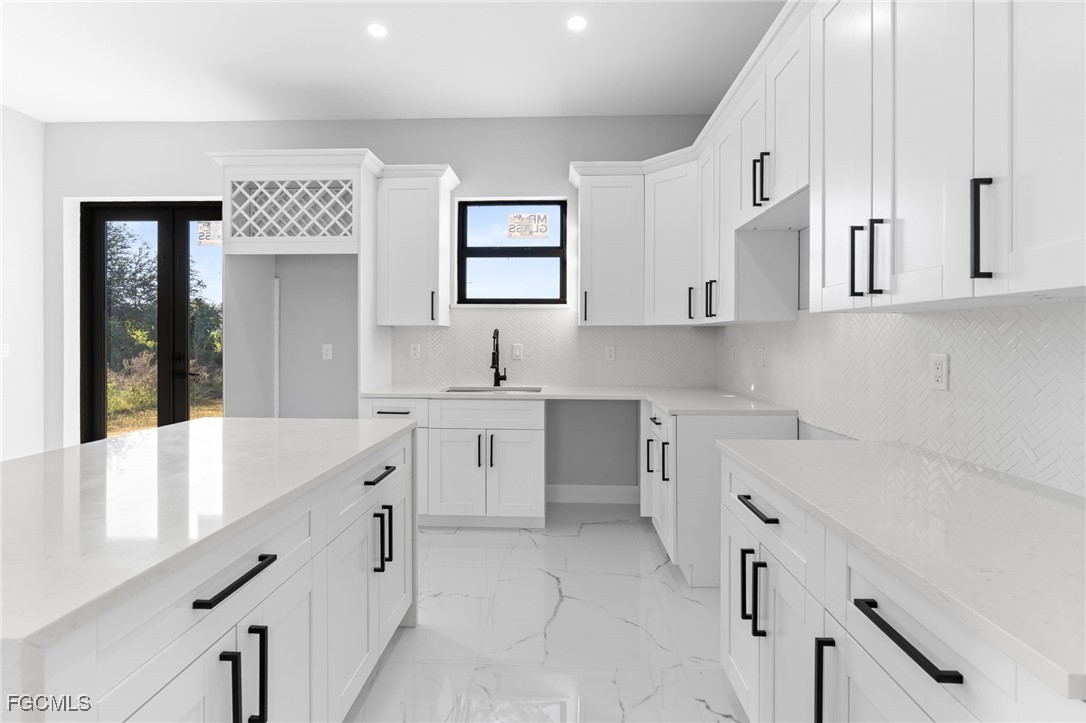 2603 3rd Street Southwest Lehigh Acres, FL 33976 - Photo 6 of 28 a kitchen with cabinets appliances and a window