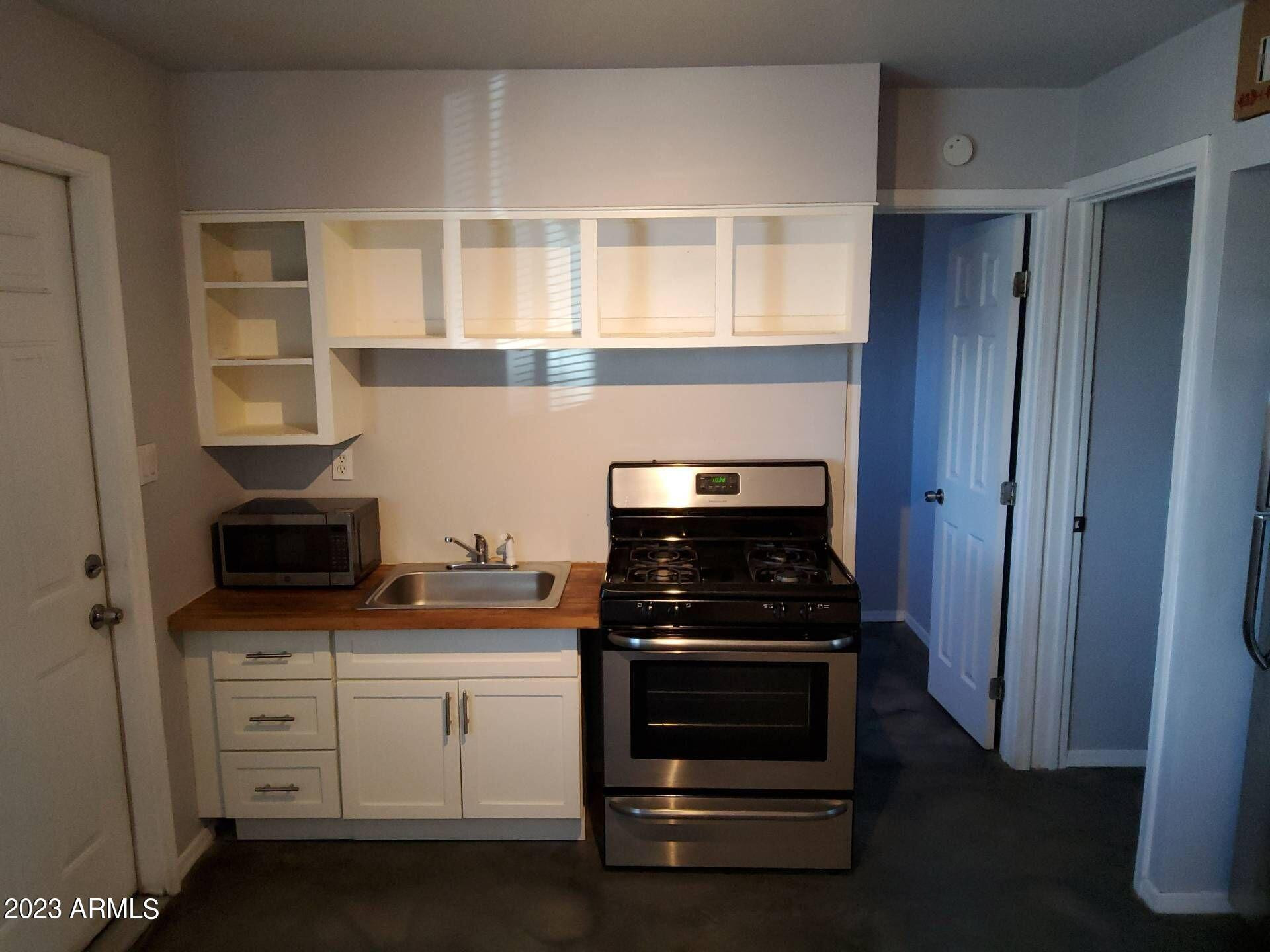 3427 North 12th Place, Unit 1 Phoenix, AZ 85014 - Photo 3 of 7 a kitchen with stainless steel appliances a stove and a microwave
