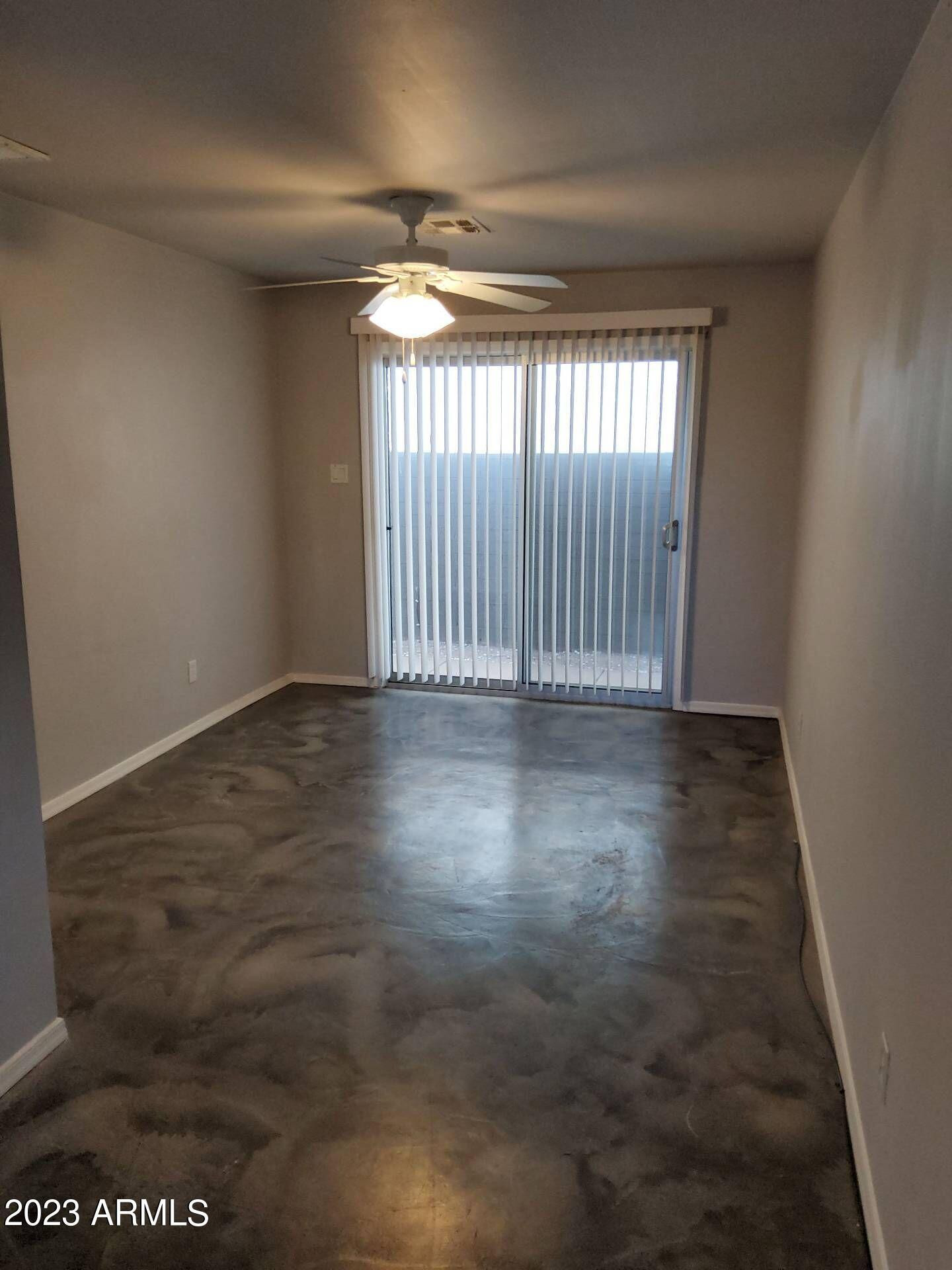 3427 North 12th Place, Unit 1 Phoenix, AZ 85014 - Photo 4 of 7 an empty room with wooden floor and windows