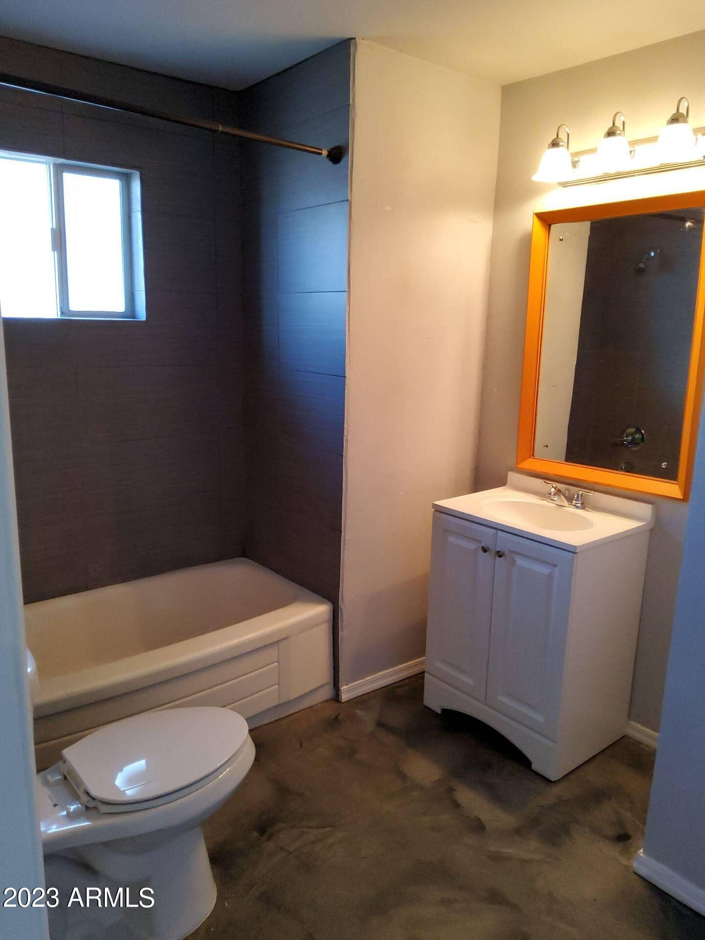 3427 North 12th Place, Unit 1 Phoenix, AZ 85014 - Photo 7 of 7 a bathroom with a toilet a sink and bathtub