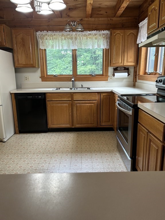 59 Paradise Lake Road Monson, MA 01057 - Photo 7 of 30 a kitchen with a stove a sink and a microwave