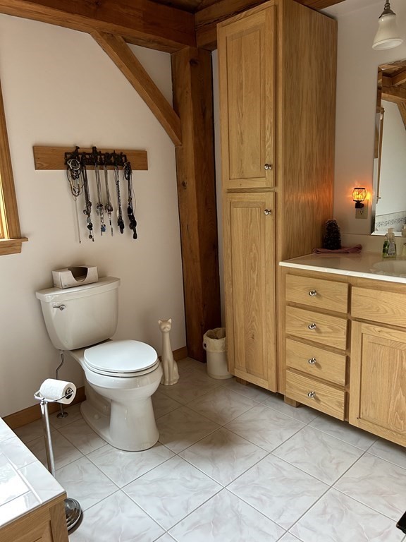 59 Paradise Lake Road Monson, MA 01057 - Photo 10 of 30 a bathroom with a toilet sink and a mirror