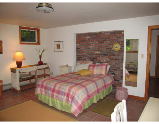 582 Pfersick Road Ashfield, MA 01370 - Photo 15 of 23 a bedroom with a bed wooden floor and lamp