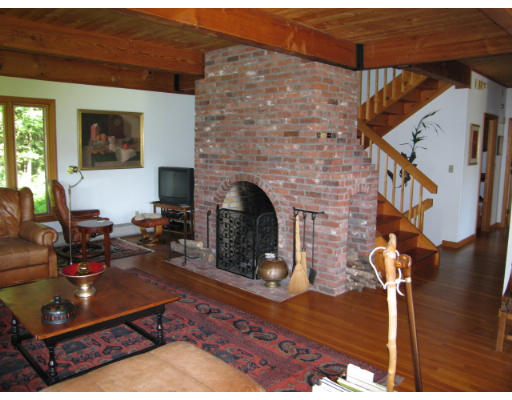 582 Pfersick Road Ashfield, MA 01370 - Photo 6 of 23 a living room with furniture a fireplace and a wooden floor