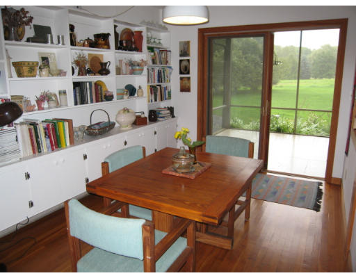 582 Pfersick Road Ashfield, MA 01370 - Photo 8 of 23 a view of a dining room with furniture and a book shelf