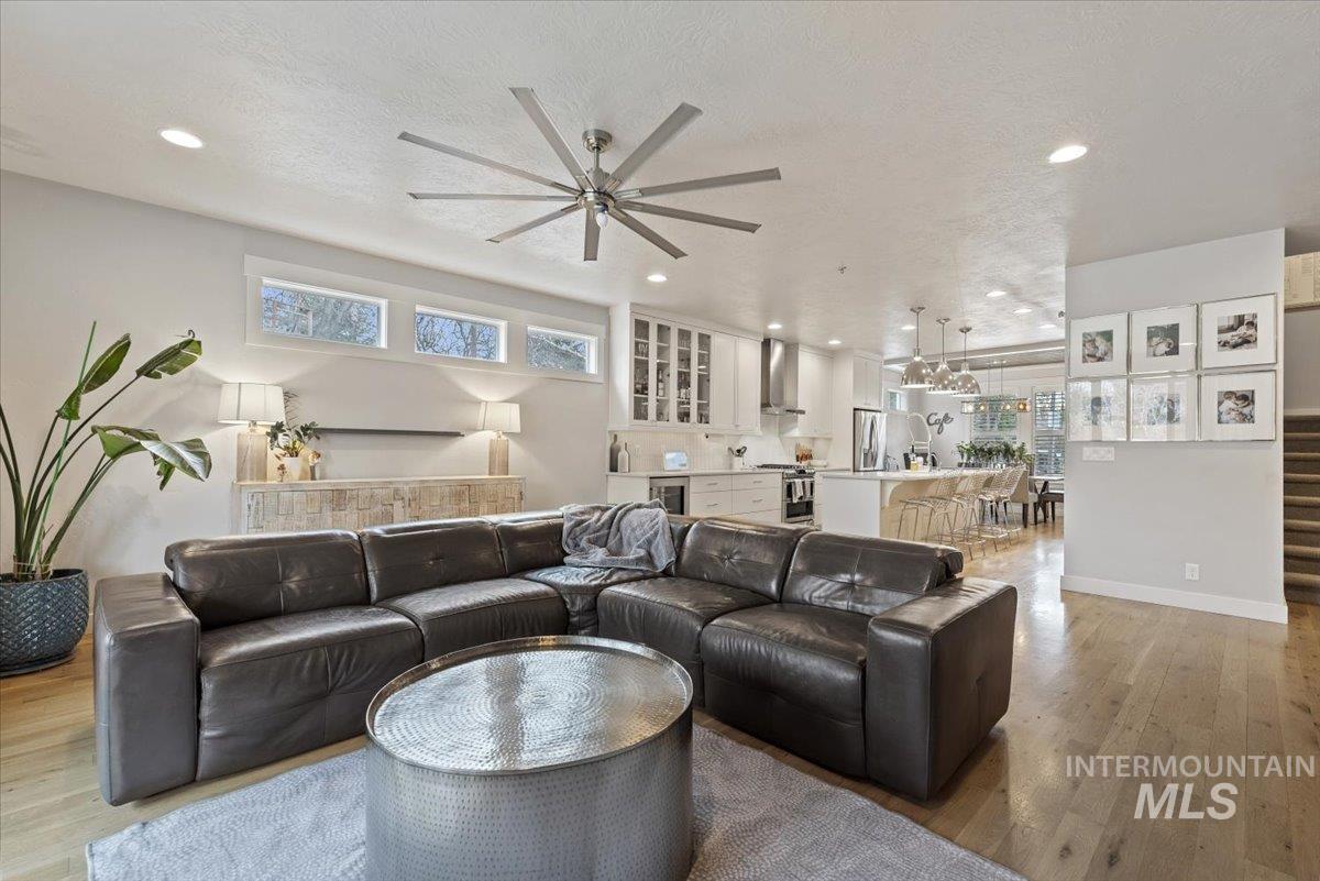 2616 West Neff Street Boise, ID 83702 - Photo 14 of 36 Living area featuring light wood-type flooring, a textured ceiling, wine cooler, recessed lighting, and stairs