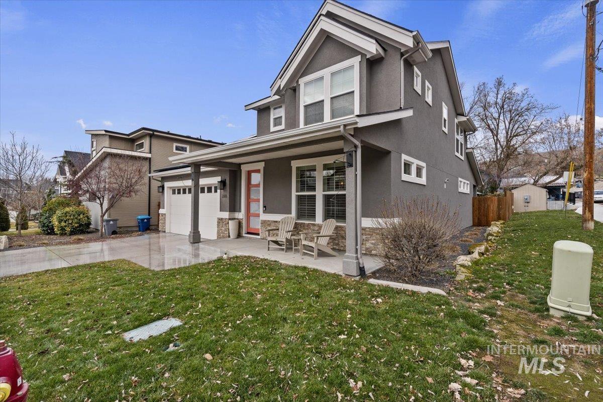 2616 West Neff Street Boise, ID 83702 - Photo 2 of 36 Traditional-style home featuring stucco siding, covered porch, a garage, concrete driveway, and stone siding