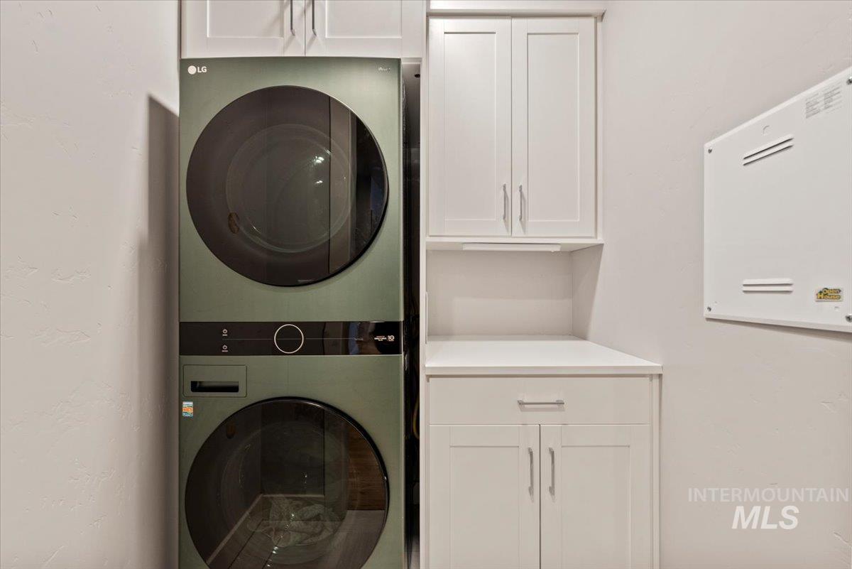 2616 West Neff Street Boise, ID 83702 - Photo 22 of 36 Laundry area with cabinet space and stacked washer / dryer
