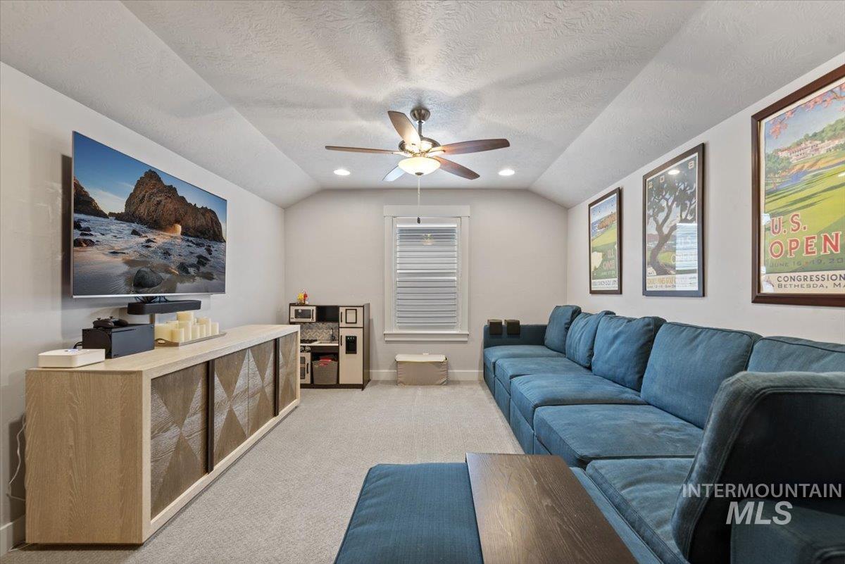 2616 West Neff Street Boise, ID 83702 - Photo 29 of 36 Living area featuring lofted ceiling, light colored carpet, ceiling fan, a textured ceiling, and recessed lighting