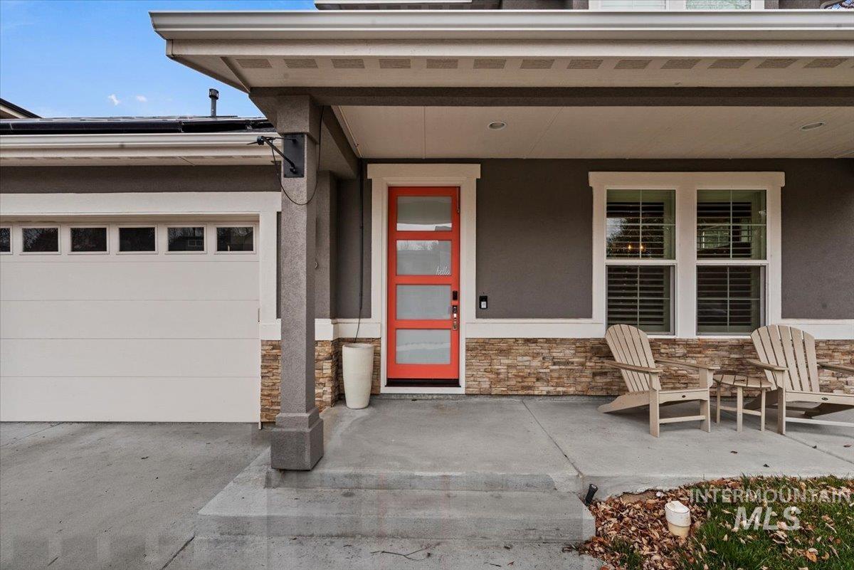 2616 West Neff Street Boise, ID 83702 - Photo 3 of 36 Entrance to property featuring stone siding, a porch, stucco siding, and a garage