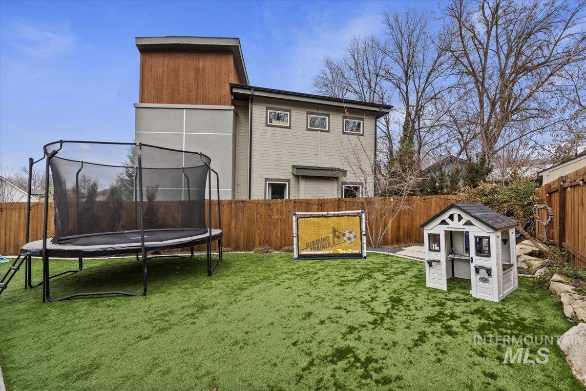 2616 West Neff Street Boise, ID 83702 - Photo 34 of 36 Rear view of house with a fenced backyard and a trampoline