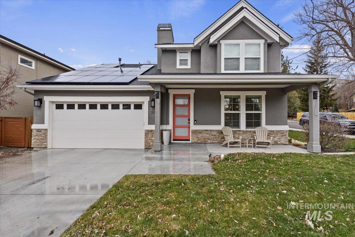 2616 West Neff Street Boise, ID 83702 - Photo 4 of 36 View of front of home with stucco siding, covered porch, stone siding, roof mounted solar panels, and a front yard