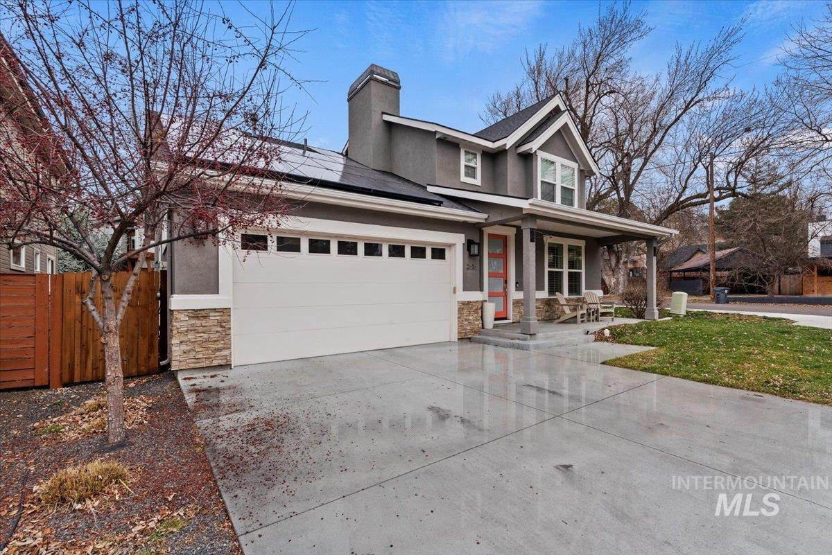 2616 West Neff Street Boise, ID 83702 - Photo 5 of 36 View of front of property featuring a porch, concrete driveway, stone siding, and stucco siding