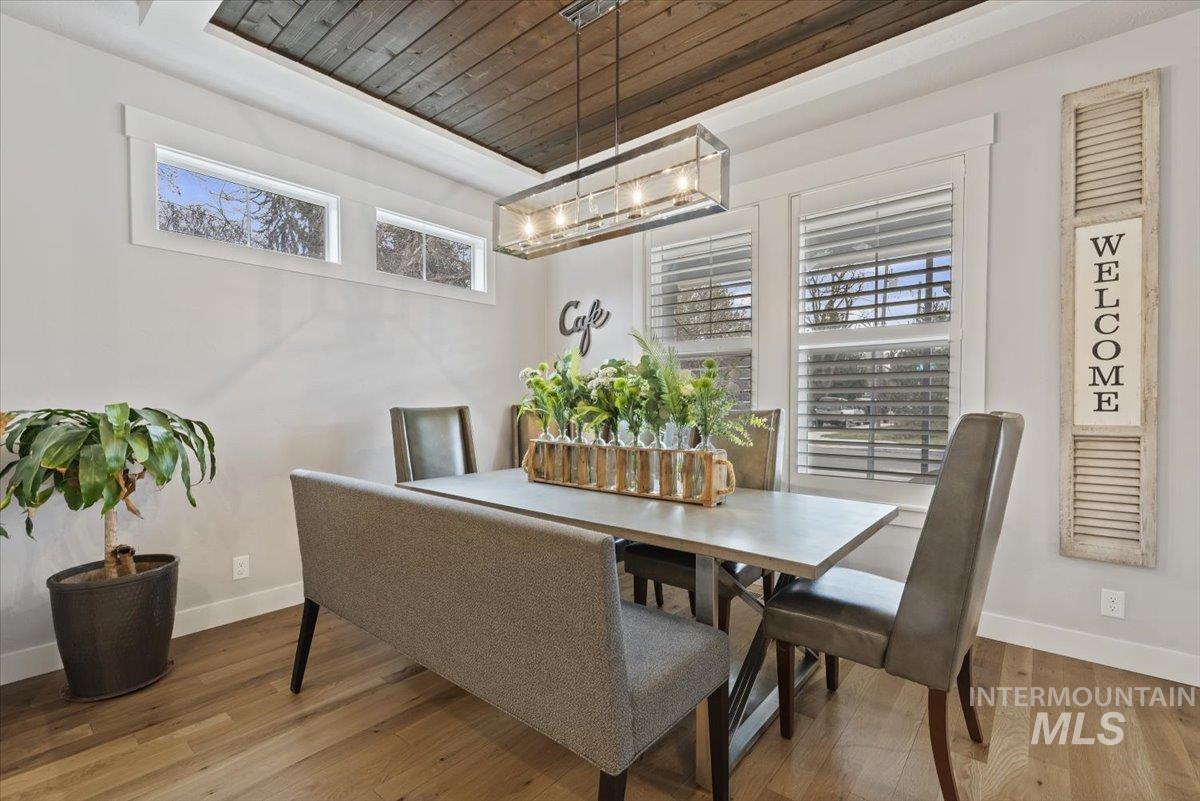 2616 West Neff Street Boise, ID 83702 - Photo 7 of 36 Dining space featuring wood ceiling, a raised ceiling, and hardwood / wood-style floors