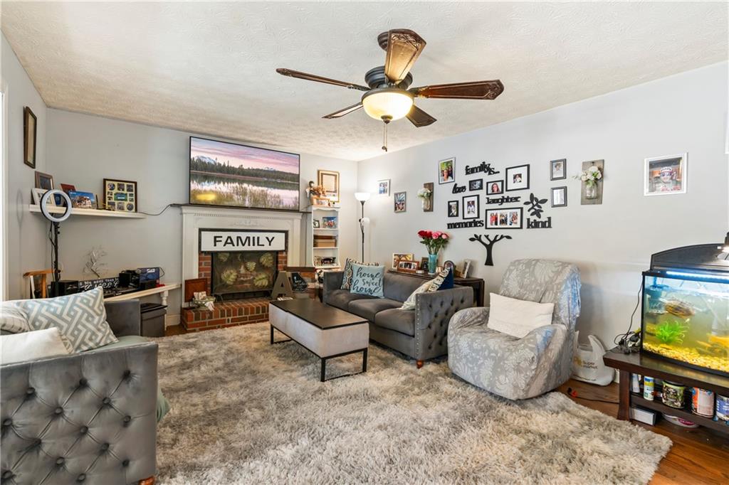 1500 Lake Dow Road McDonough, GA 30252 - Photo 11 of 42 a living room with furniture a fireplace and a flat screen tv