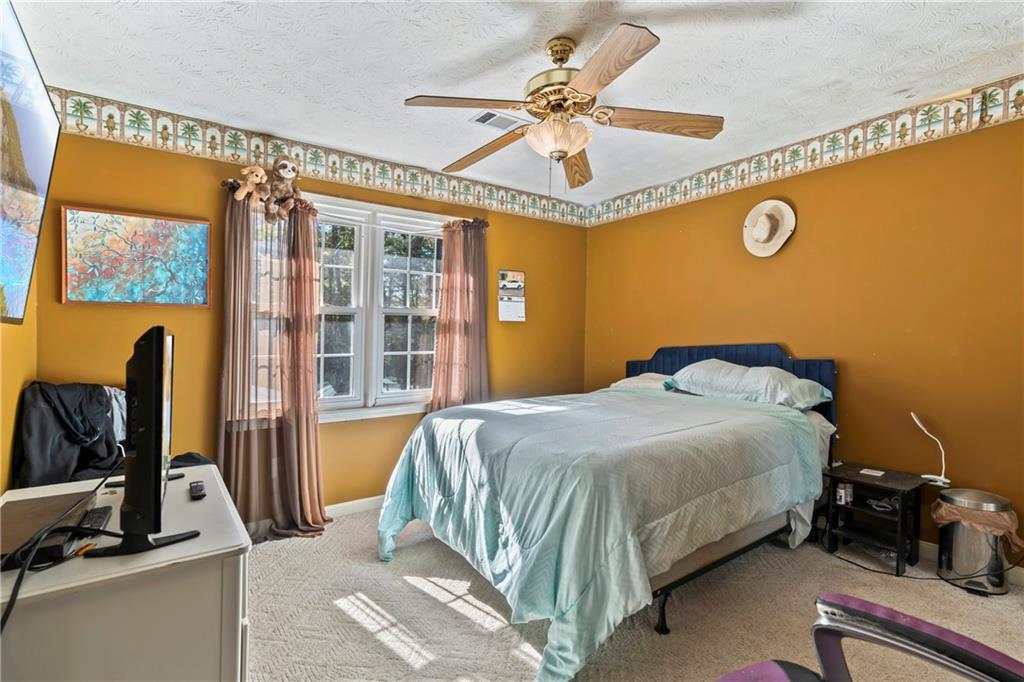 1500 Lake Dow Road McDonough, GA 30252 - Photo 22 of 42 a bedroom with a bed and a chandelier