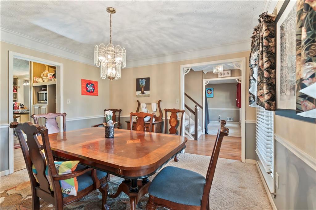1500 Lake Dow Road McDonough, GA 30252 - Photo 8 of 42 a view of a dining room with furniture and a chandelier
