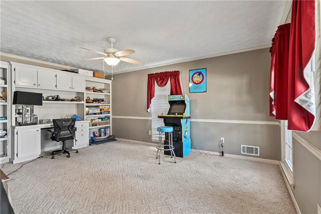 1500 Lake Dow Road McDonough, GA 30252 - Photo 9 of 42 a view of a workspace with furniture and a kitchen