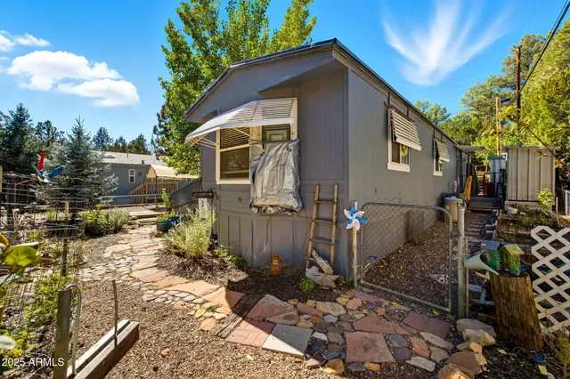 a view of a backyard with wooden fence