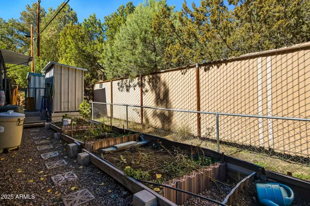 a view of a small house with a tree in the background