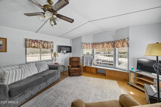 a bedroom with furniture and a large window