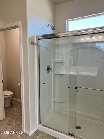a bathroom with a shower and toilet