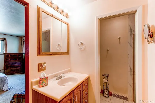 a bedroom with a bed chair and window