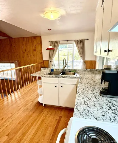 a kitchen with a sink and a stove top oven
