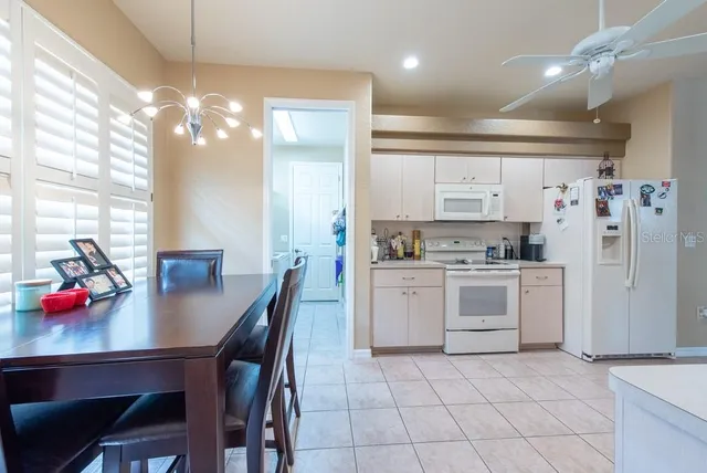 a open kitchen with white cabinets and stainless steel appliances