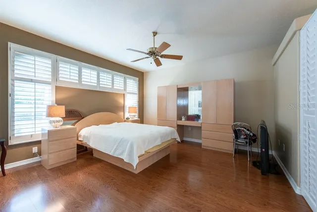 a bedroom with a bed and a chandelier