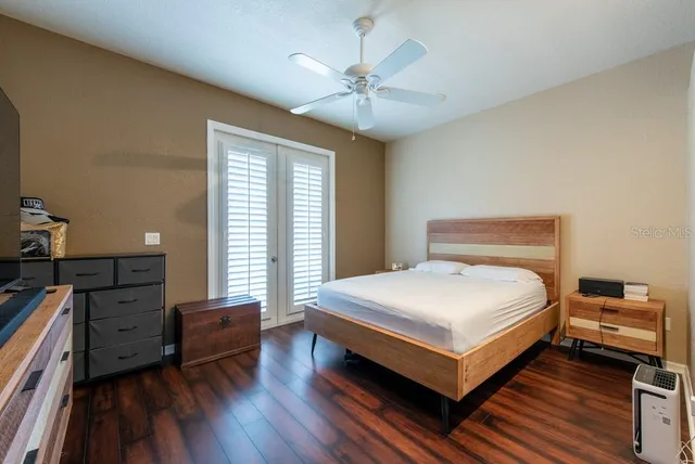 a bedroom with a bed and a chandelier