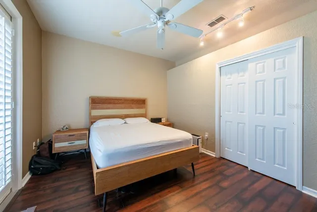 a bedroom with a bed and wooden floor
