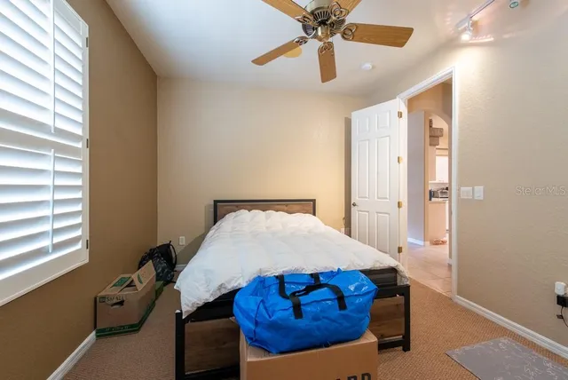 a bed room with a bed and a window