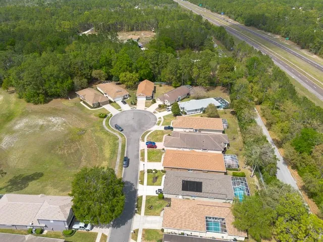 an aerial view of a house with a yard