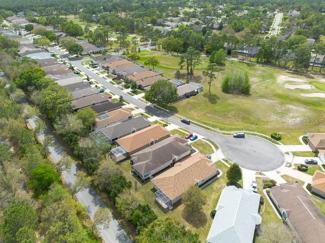 an aerial view of residential houses with outdoor space and river