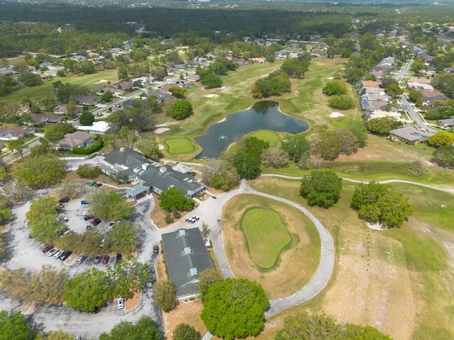 a aerial view of residential house with swimming pool and green space