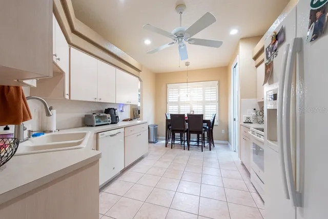 a kitchen with granite countertop cabinets a sink a window and stainless steel appliances
