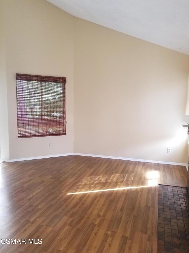 1754 Sinaloa Road, Unit 275 Simi Valley, CA 93065 - Photo 6 of 18 an empty room with wooden floor and windows