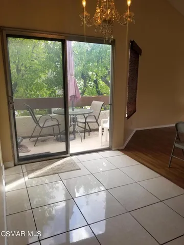 a view of a room with wooden floor and outdoor space
