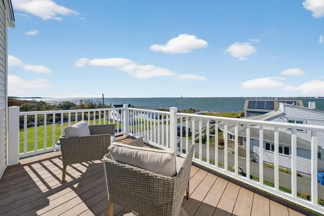 a balcony with wooden floor and city view