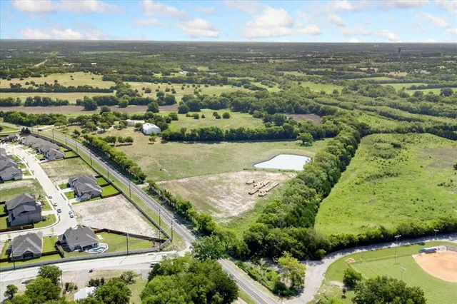 an aerial view of residential houses with outdoor space and river